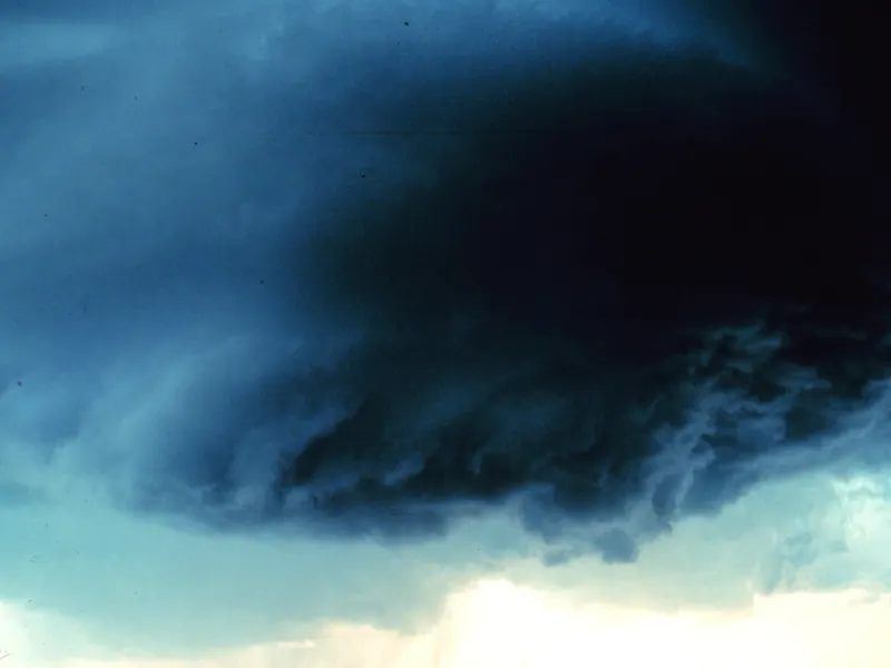 A dark, round, lowered cloud base hanging beneath a storm